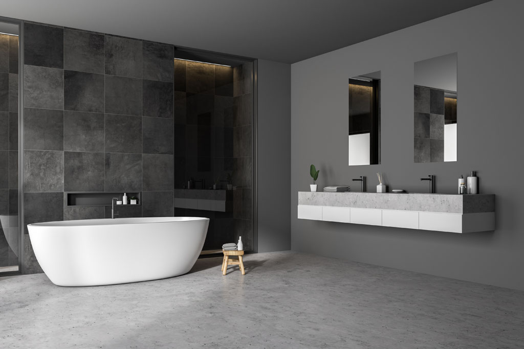 Modern bathroom corner with black tile walls, concrete floor, white bathtub and double sink. 3d rendering